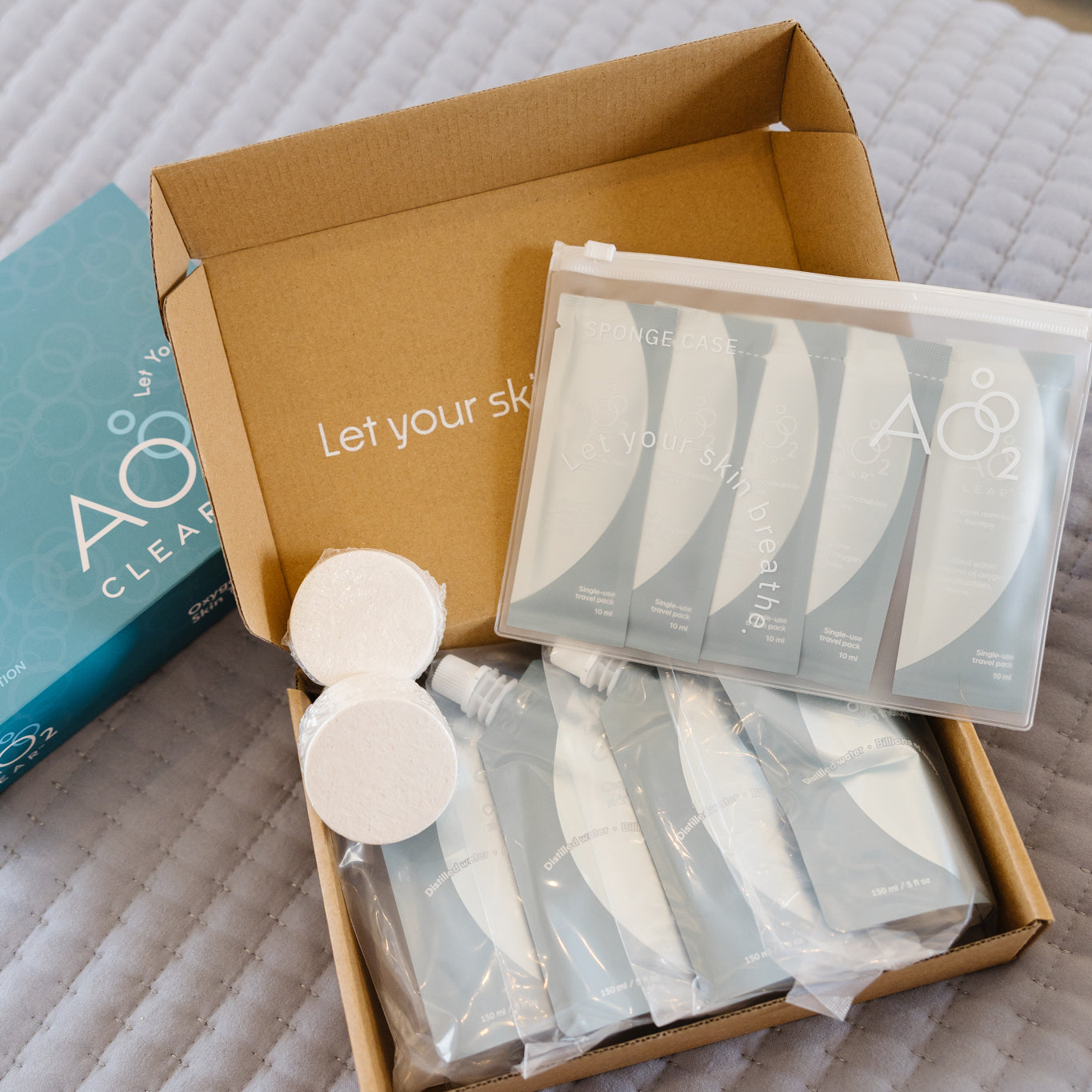 Box of skincare products with AO2 packaging on a textured surface