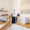Person holding a bottle of Wish Conditioning Hydra-Mist in an estheticians office