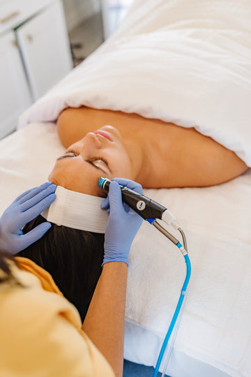 Person receiving a medical procedure on their abdomen with gloves on hands